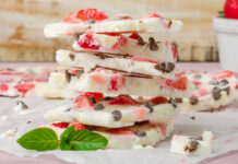 Frozen Yogurt Bark With Berries Recipe Homemade healthy frozen strawberry yogurt bark on rustic wooden background