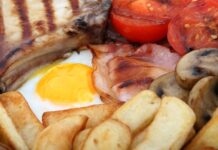 Have You Ever Made Ham, Egg, and Chips Before? Ham with a fried egg, French fries, and vegetables