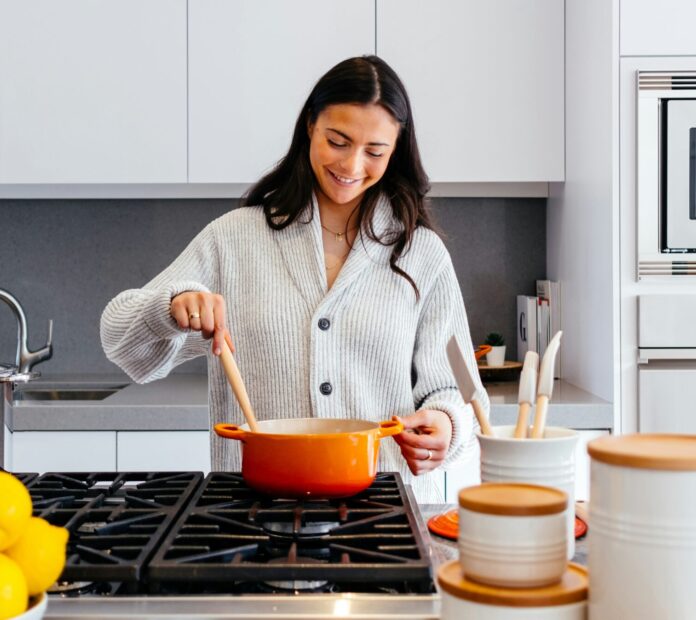Woman stirring a pot in a kitchen