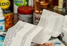 How to Spend Less Money at The Supermarket Groceries with a long receipt