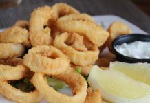 You’ll Love This Crispy Fried Calamari Recipe Fried calamari with lemon wedges and sauce