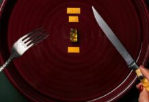 Homemade Gummy Bears With Simple Ingredients Person Holding A Fork and Knife With Gummy Bear and Sticker On Plate
