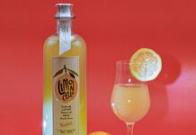 This Limoncello Spritz Will Quench Your Summer Thirst Glass and Bottle of Limoncello